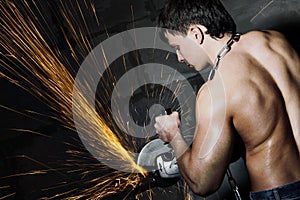 Worker cuts metal