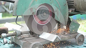 Worker cuts a metal pipe with some electric device or appliance