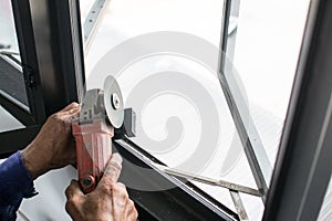 worker cuts a metal pipe with some electric device or appliance