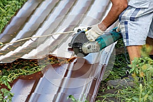 A worker cuts a metal roof for the roof