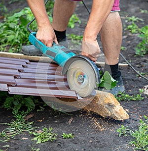 A worker cuts a metal roof for the roof