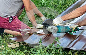 A worker cuts a metal roof for the roof