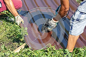 A worker cuts a metal roof for the roof