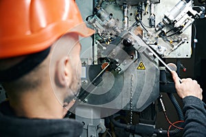 Worker cuts spacer frames in a window production