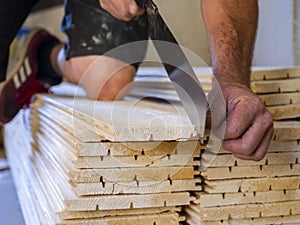 worker cuts wooden slats