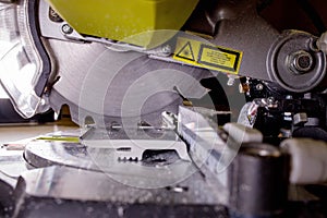 Worker cutting baseboard on the circular saw before installing