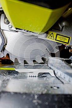 Worker cutting baseboard on the circular saw before installing