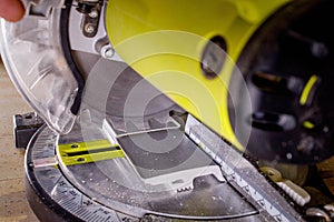 Worker cutting baseboard on the circular saw before installing