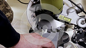 Worker cutting baseboard on the circular saw before installing