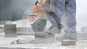 Worker cutting the brick pavers