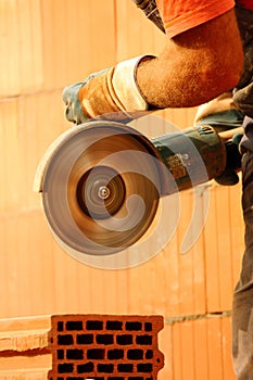 Worker cutting bricks