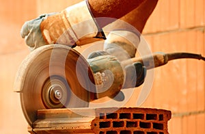 Worker cutting bricks