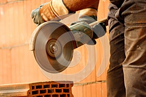 Worker cutting bricks