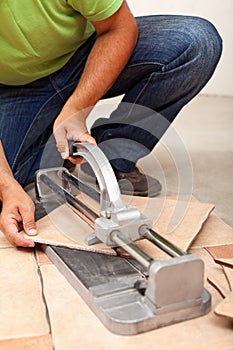 Worker cutting ceramic floor tiles