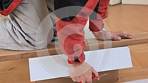 Worker cutting gypsum board