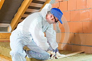 Worker cutting insulating material