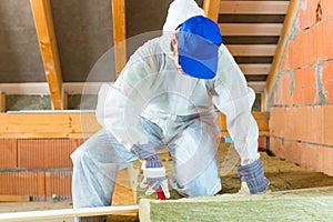 Worker cutting insulating material photo