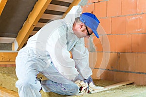Worker cutting insulating material photo