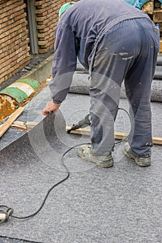 Worker cutting insulation material for basement wall 2