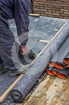 Worker cutting insulation material for basement wall 4