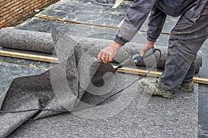 Worker cutting insulation material for basement wall photo