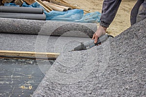 Worker cutting insulation material for basement wall 3