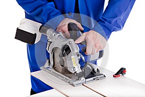 Worker cutting laminate with circular power saw