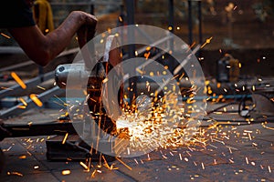 A Worker cutting metal with grinder