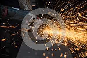 Worker cutting metal with grinder.Spark while grinding iron