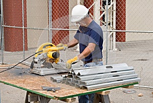 Worker Cutting Metal Studs