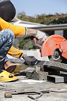 Worker cutting metal with unsafety position