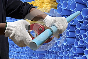 Worker cutting pvc pipe