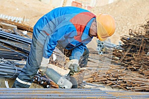 Worker cutting rebar by grinding machine