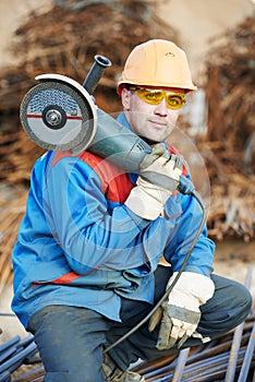 Worker cutting rebar by grinding machine