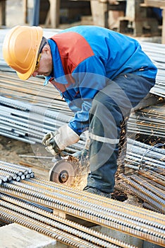 Worker cutting rebar by grinding machine