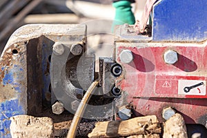 The worker is cutting rebars with rebar cutting machine in the site. The most common type of rebar is carbon steel.