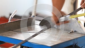 Worker cutting steel for house building