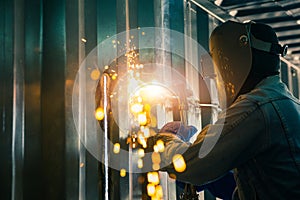 Worker cutting steel sheet by gas cutting