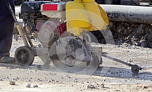 Worker cutting stone block by cutter machine