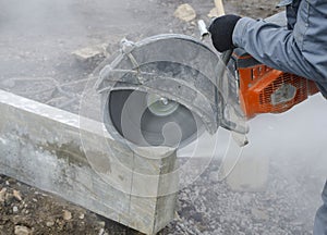 Worker cutting stone block.