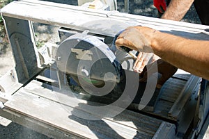 Worker cutting stone block by cutter machine