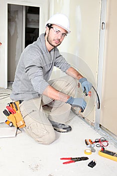 Worker cutting a wire