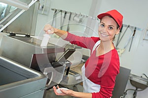 Worker deep frying in industrial kitchen