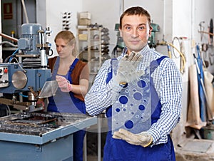 Worker demonstrating glass with bores