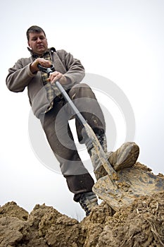 Worker digging in the ground