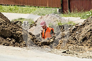 Worker digging a trench for sewer