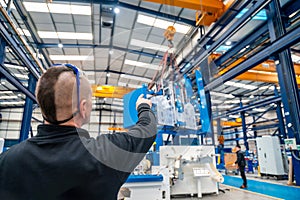 Worker directing the maneuvers of an industrial crane