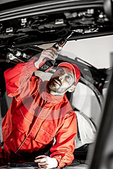 Worker disassembling car interior
