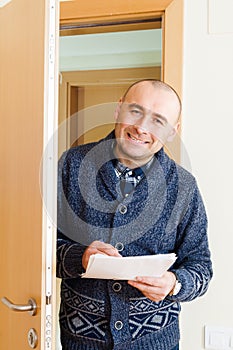 Worker with documents in doorway