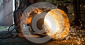 Worker doing a industrial welding in a workshop